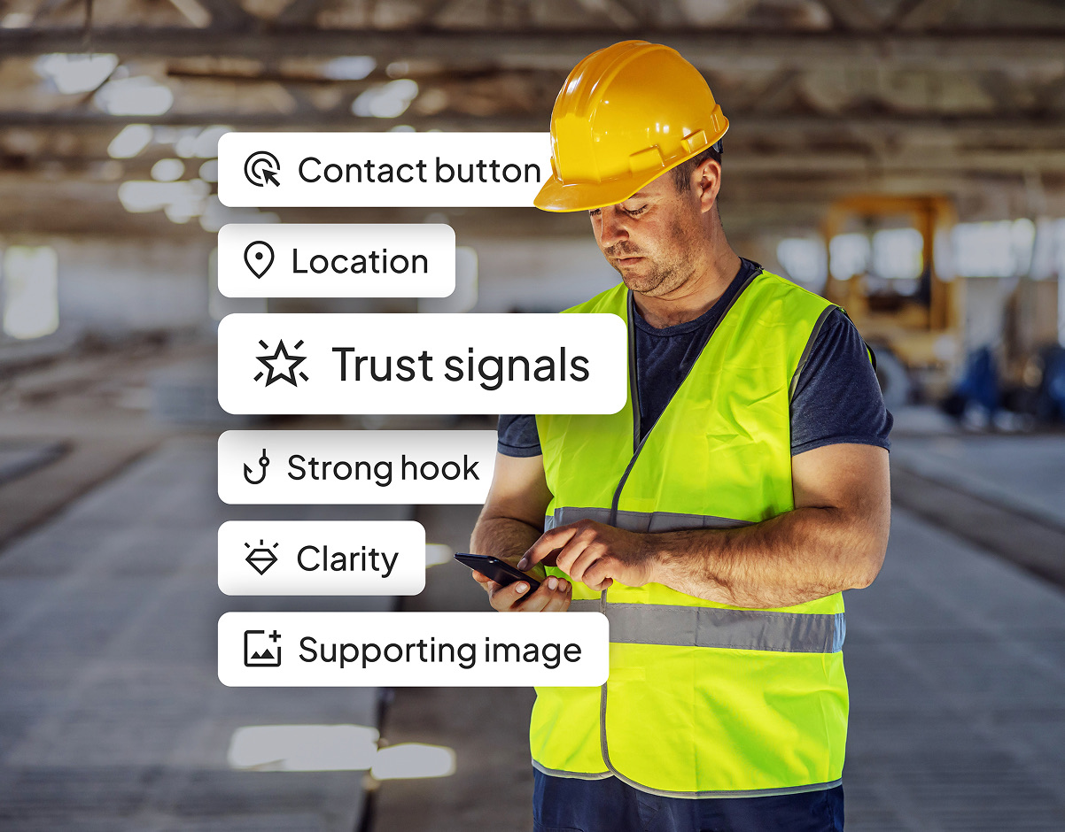 A builder in a hard hat and hi-vis checking his phone on site, with labels for a contact button, location, trust signals, a strong hook, clarity and a supporting image